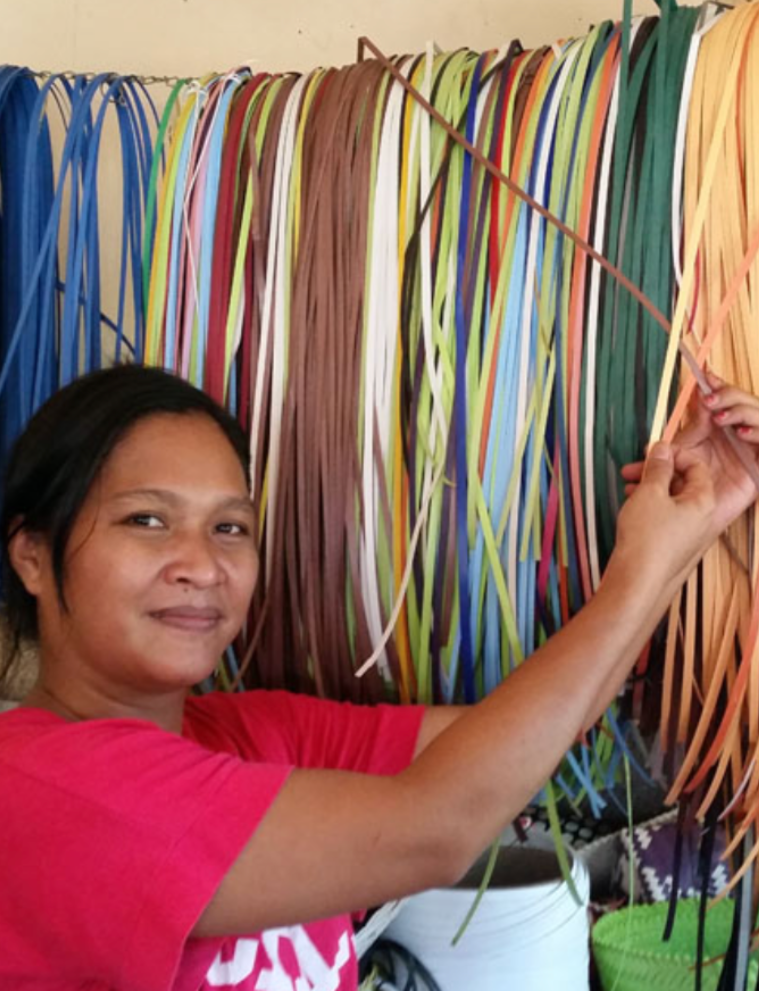 Woman working with colorful ribbons in a craft setting